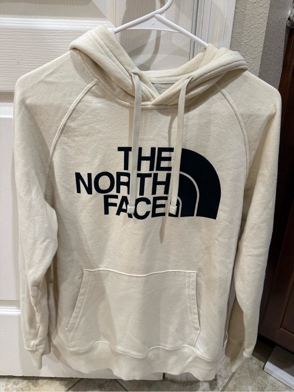 The North Face Cream Pullover Hoodie with Black Logo and Pocket